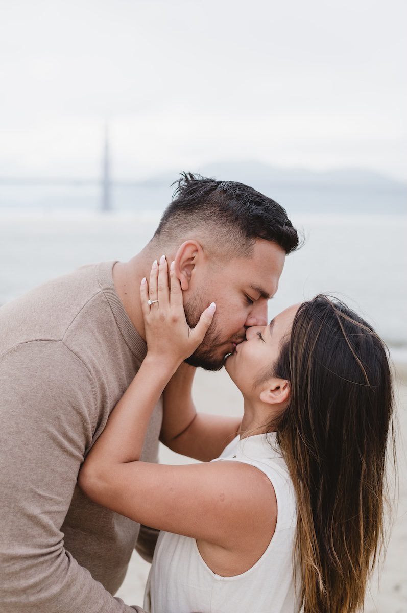 women and man kissing after they she had a surprise proposal then engagement session in San Francisco, California by Photographer Jen Vazquez