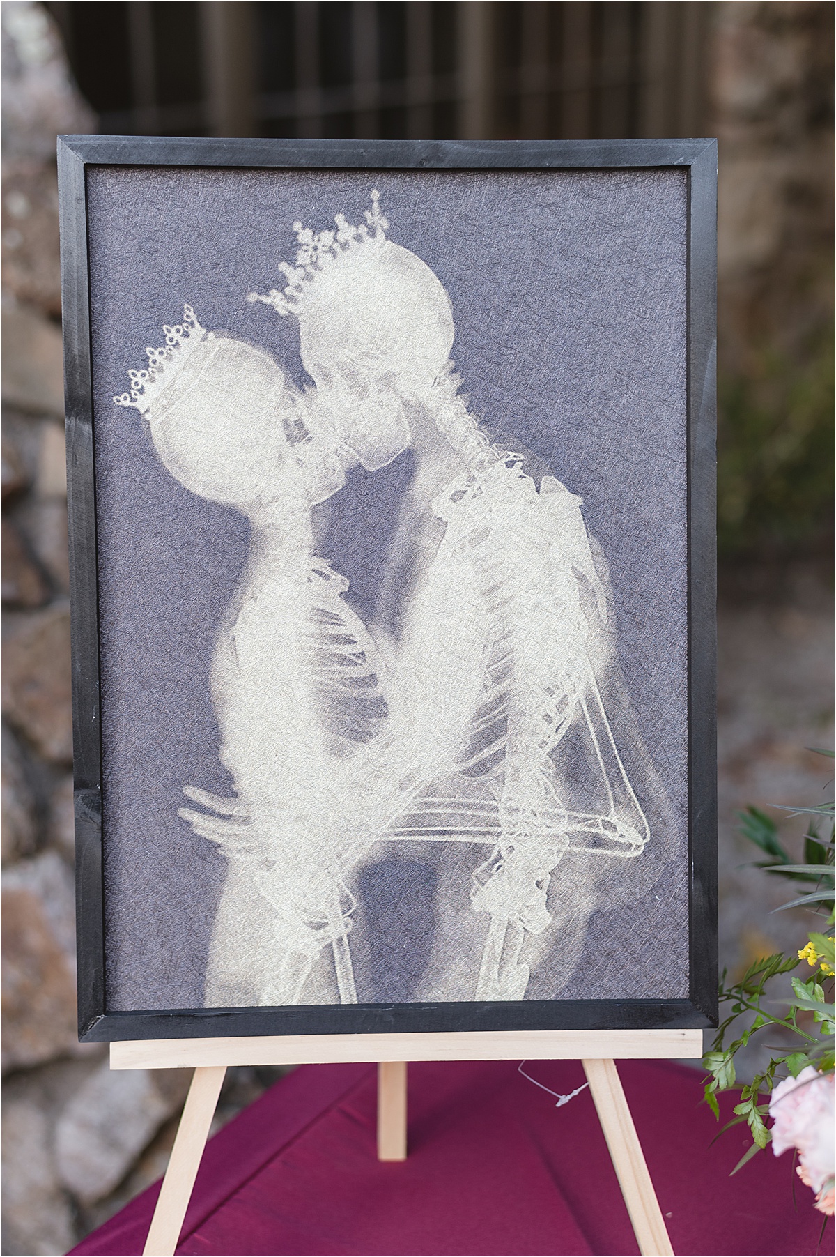 Photo of skeletons kissing with crowns on at this halloween wedding