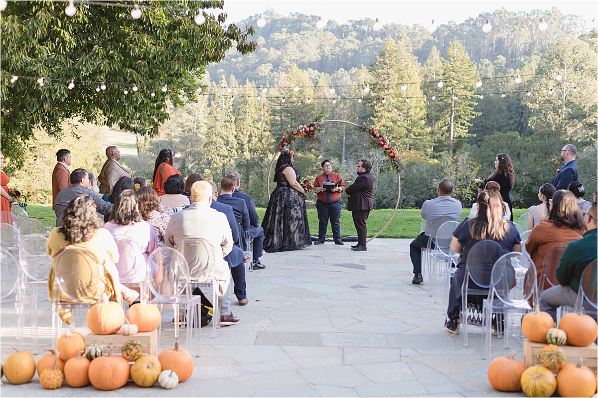 at the altar of this halloween wedding with bride in a black dress