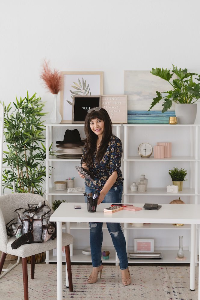 Monina Wright of Moderne Beauty with makeup out on a table to do makeup on a client for her brand photoshoot in the Los Altos studio The Sunlight Space by photographer Jen Vazquez