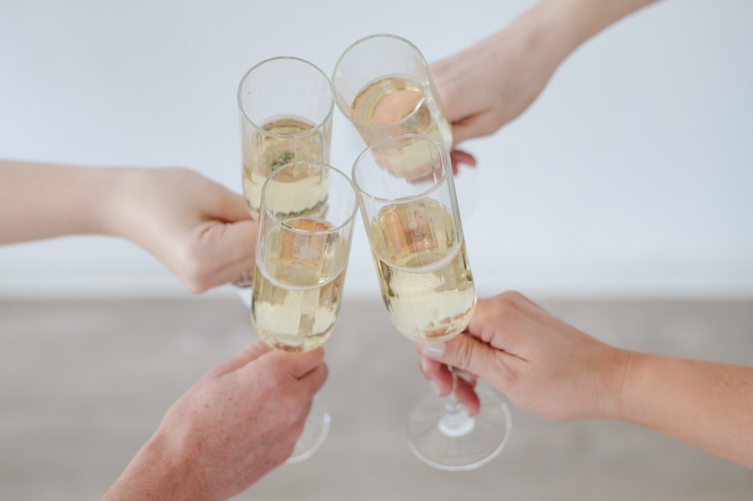 flutes of Champagne in a four-way cheers at The Sunlight Space Studio in Los Altos, California by Bay Area Brand Photographer Jen Vazquez