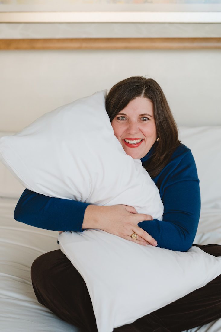 women holding a pillow to sell her services on helping children sleep happy consulting