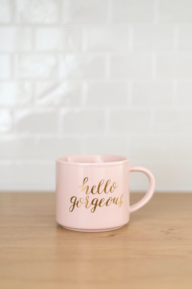 A pink coffee cup saying Hello Beautiful against white tile talking about Brand Photography at The Sunlight Space in the Bay Area, California