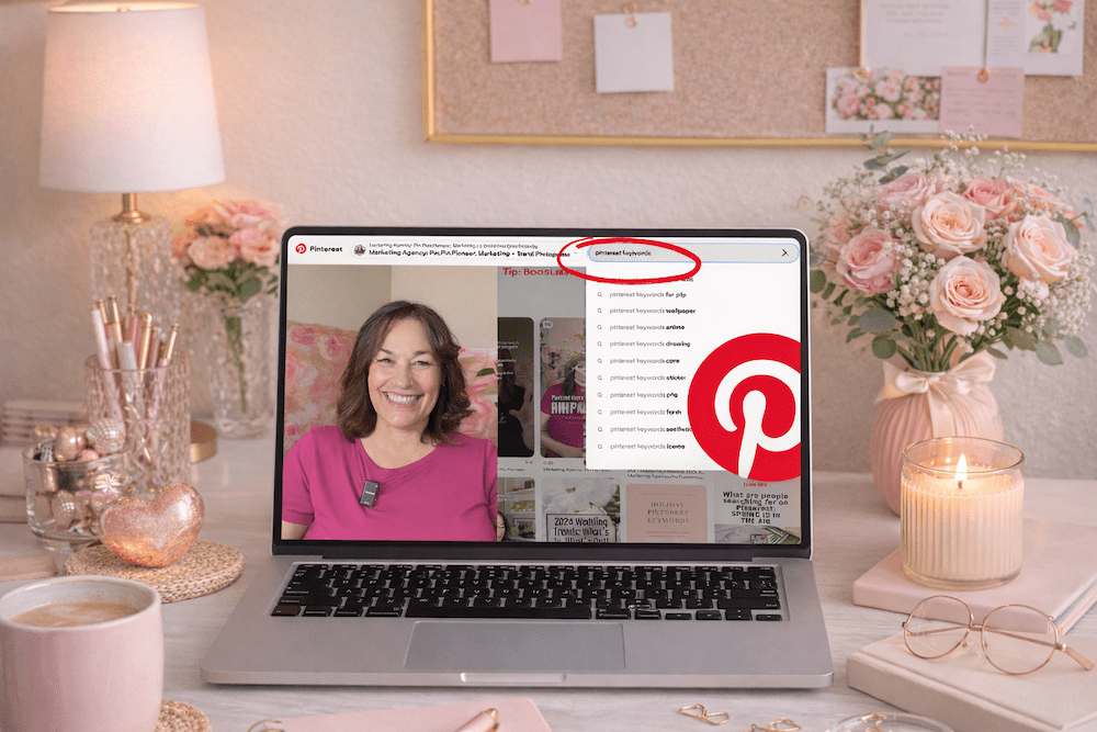 image of a feminine pink office with a laptop and on the screen is a video of How to Find + Use Pinterest Keywords That Actually Get Your Content Found.